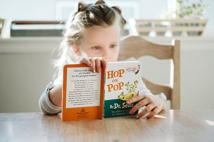 Child reading a book for school