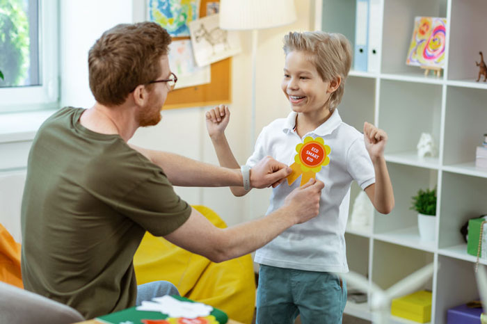 school pupil getting rewarded by teacher