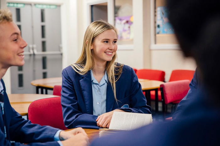 student talking with others