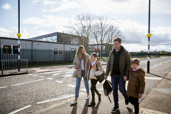 Parents and students crossing road