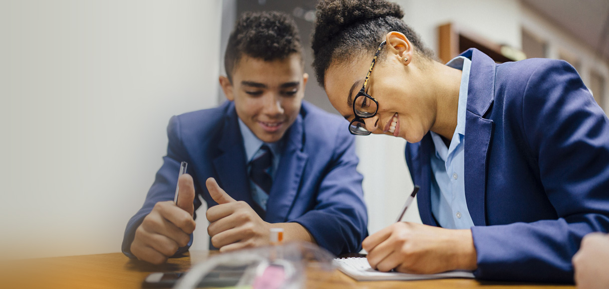 students writing in their planner