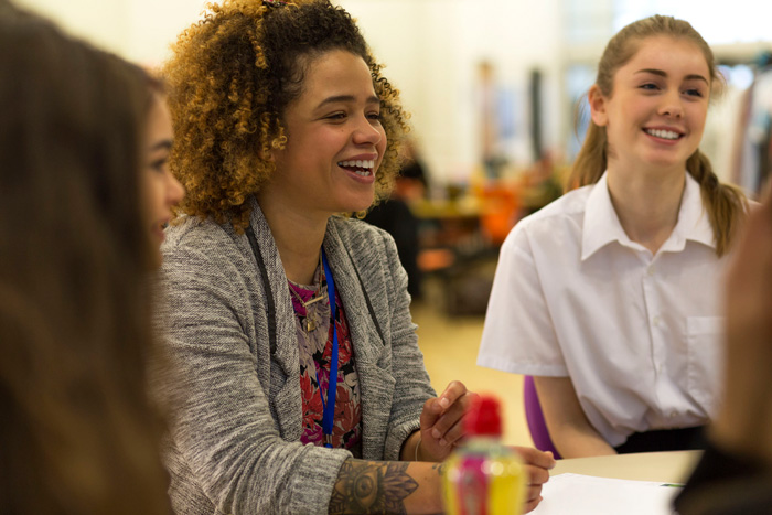 teacher smiling with students