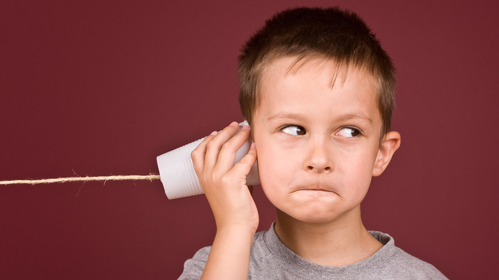 boy with string telephone showing speech and language challenges