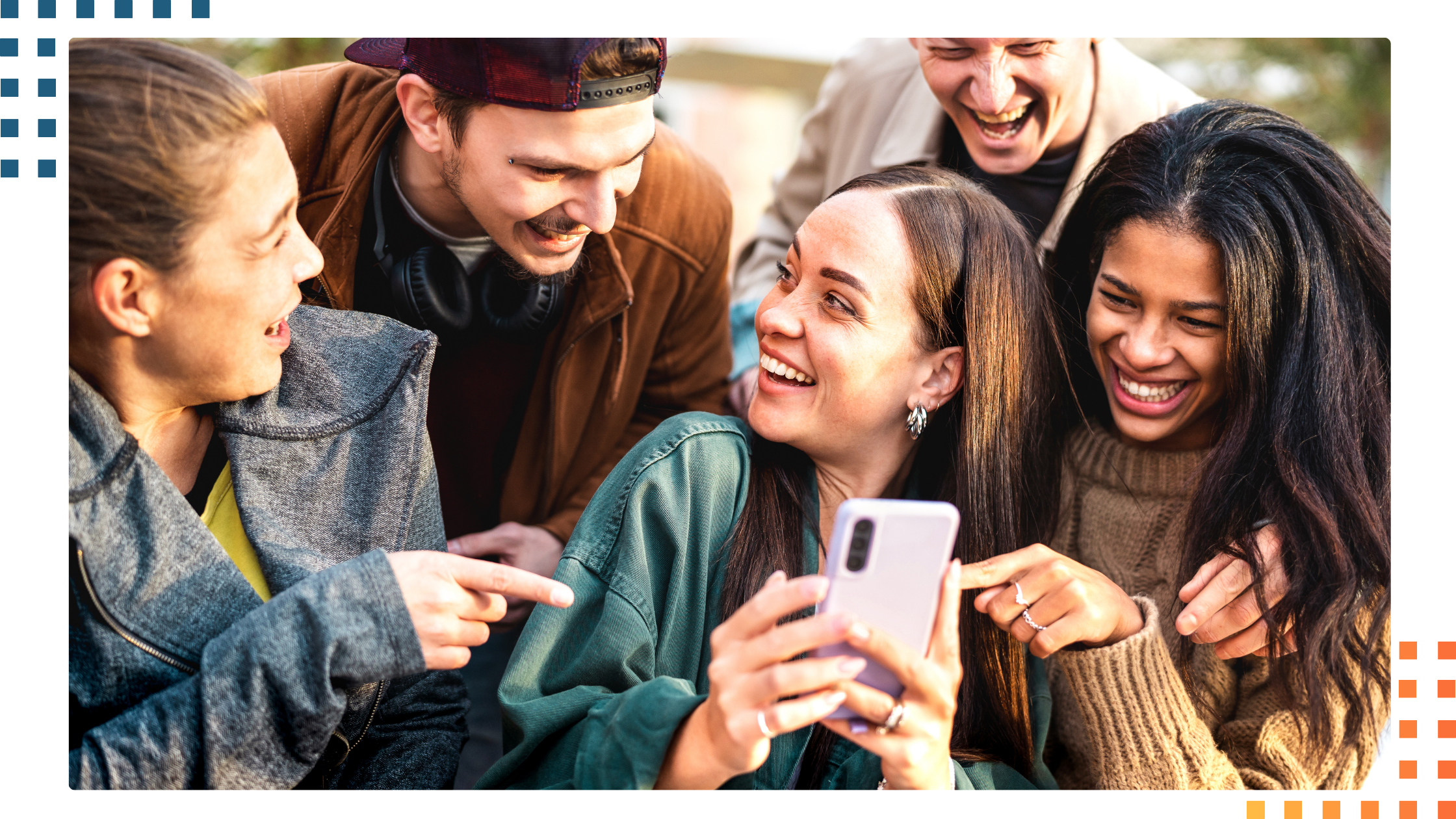 Gen Z students using a smartphone and laughing together, showing how technology connects and engages Generation Z.